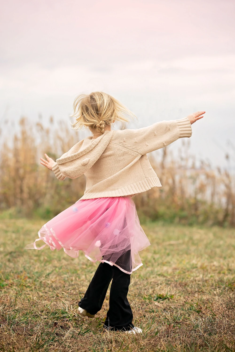 A little girl discovering the world beside the water