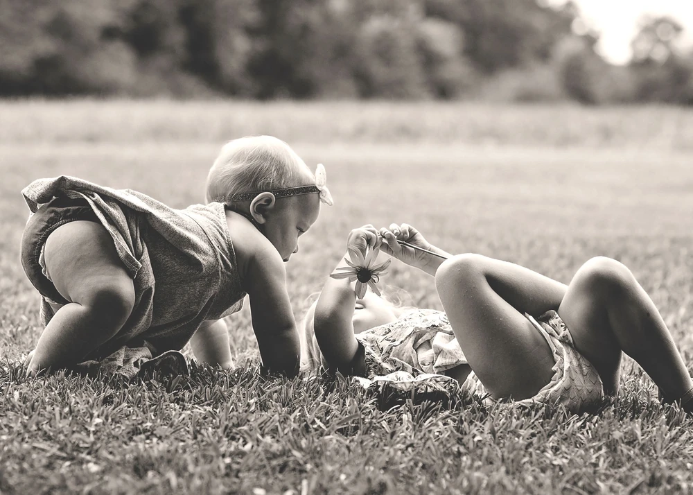 A playful family moment together in the grass