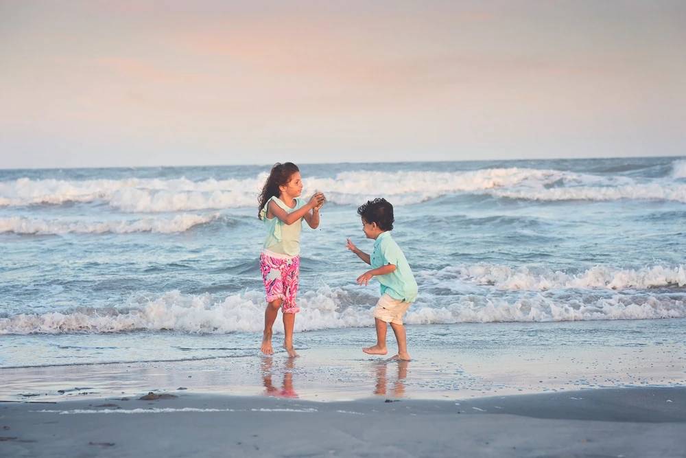 Children playing together in the ocean waves